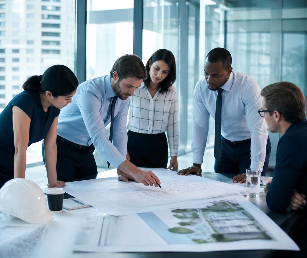 Consulting team reviewing infrastructure plans in a modern office